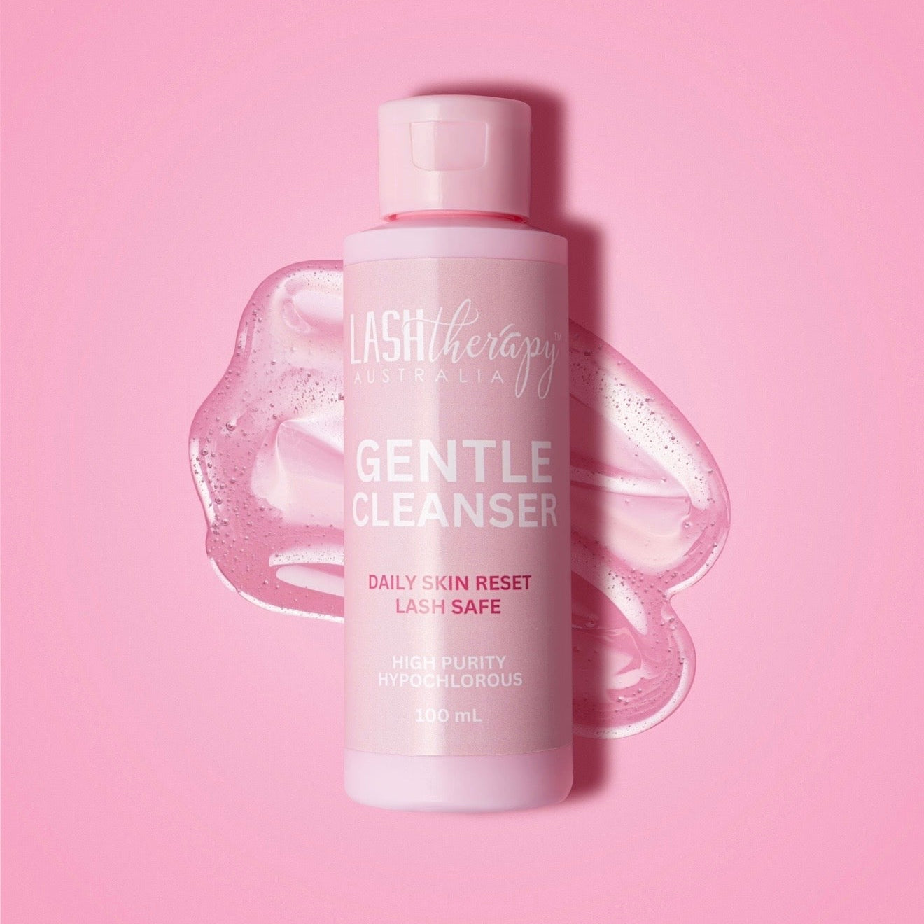 Bottle of Lash Therapy Gentle Cleanser on a pink background