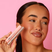 Model holding Lash Therapy Australia eyebrow serum and brow gel for fuller looking brows